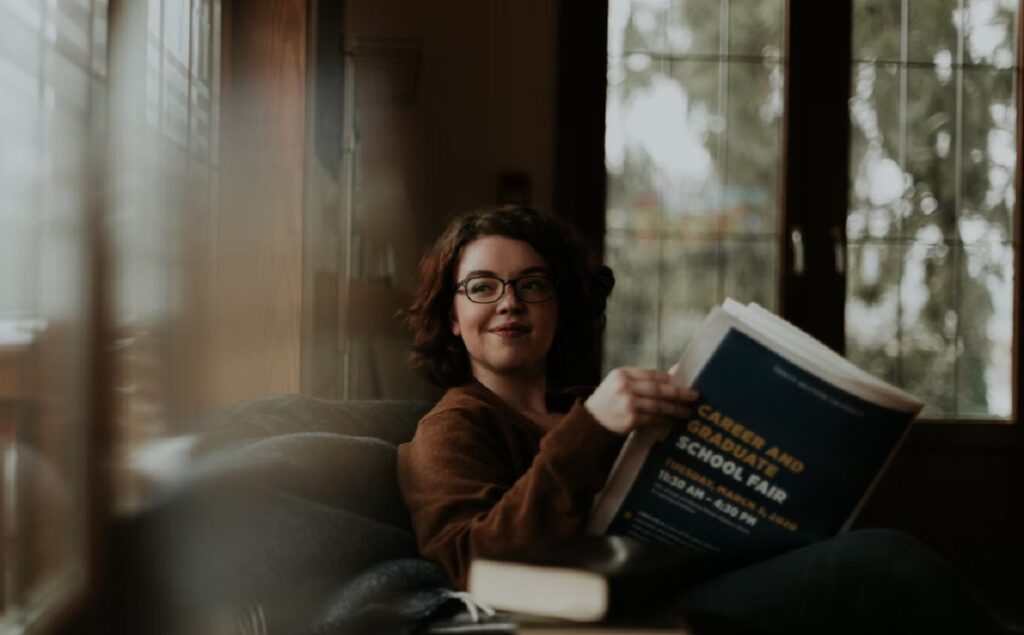 Student browsing a grad school catalog.